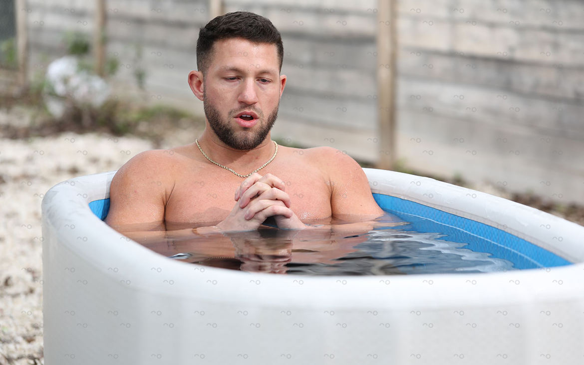 Man is submerged in a cold plunge tub